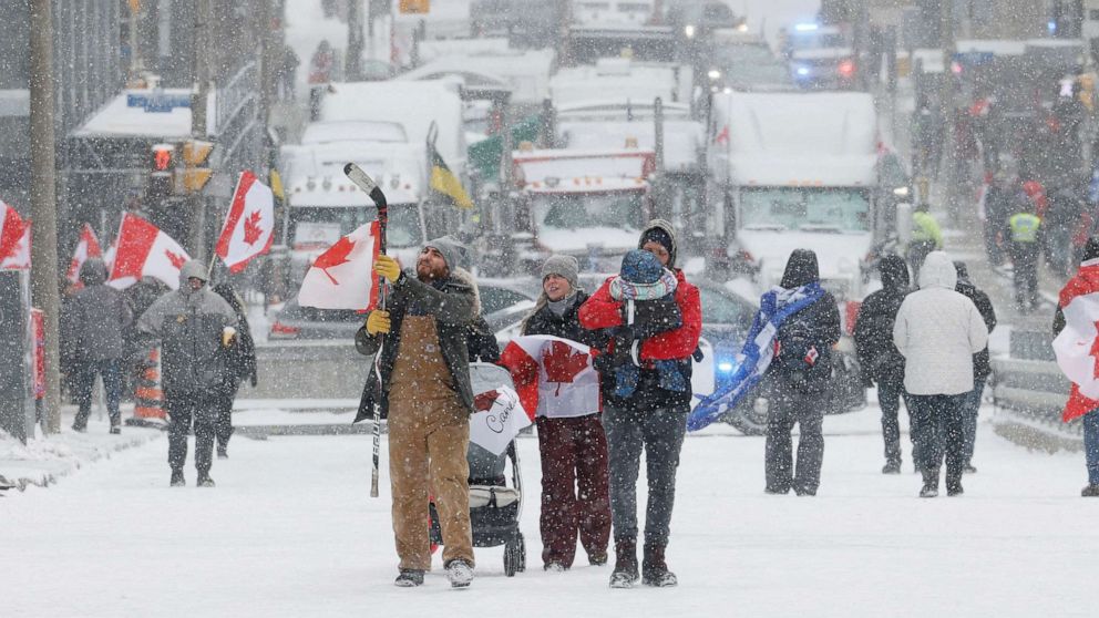 PHOTO: Demonstrators walk downtown as truckers and their supporters continue to protest coronavirus vaccine mandates, in Ottawa, Ontario, Canada, Feb. 12, 2022.