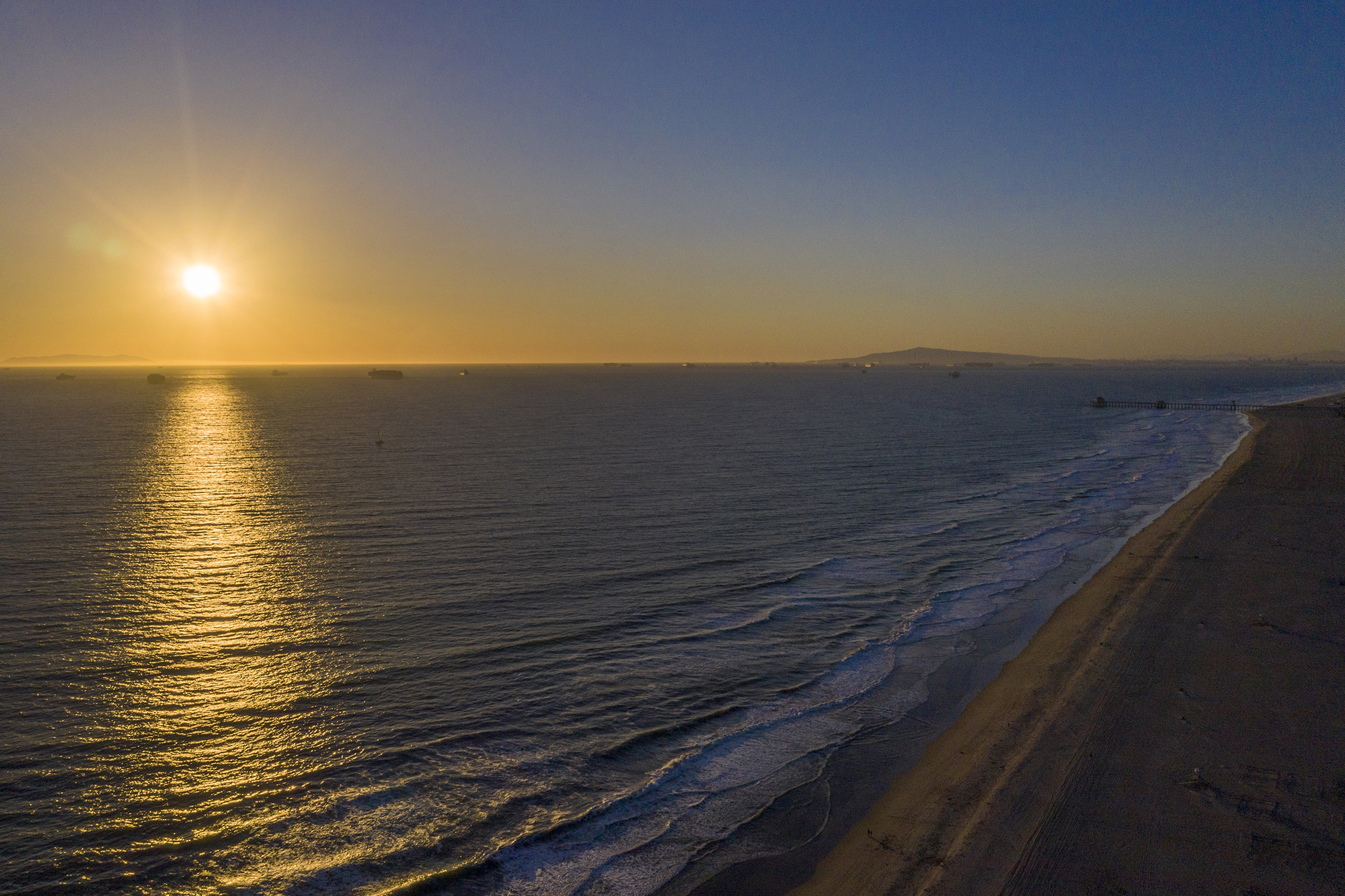 PHOTO: The sun sets over the Pacific ocean in Huntington Beach, Calif., Feb. 17, 2021. ocean at