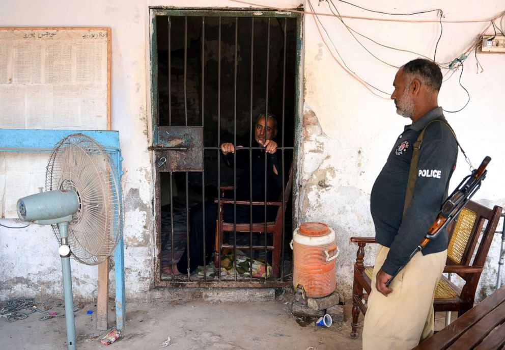 PHOTO: Pediatrician, Dr. Muzaffar Ghanghro, who authorities suspect knowingly spread HIV, sits behind bars on May 9, 2019, at a local police station in Sindh province, Pakistan.