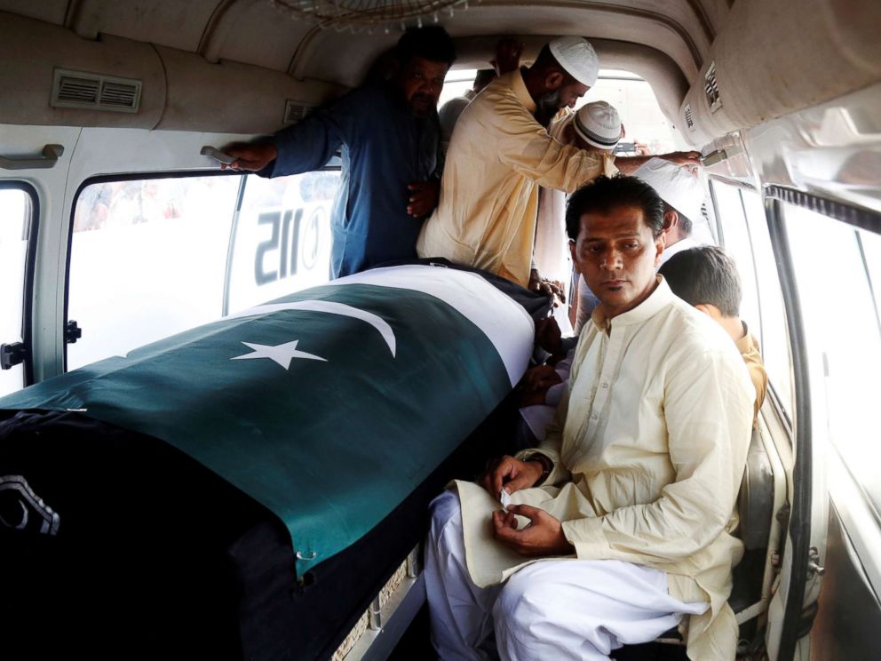 PHOTO: Aziz Sheikh father of Sabika Aziz Sheikh, who was killed when a gunman attacked Santa Fe High School in Santa Fe, Texas, sits in an ambulance next to her coffin, wrapped in national flag, during a funeral in Karachi, Pakistan May 23, 2018.