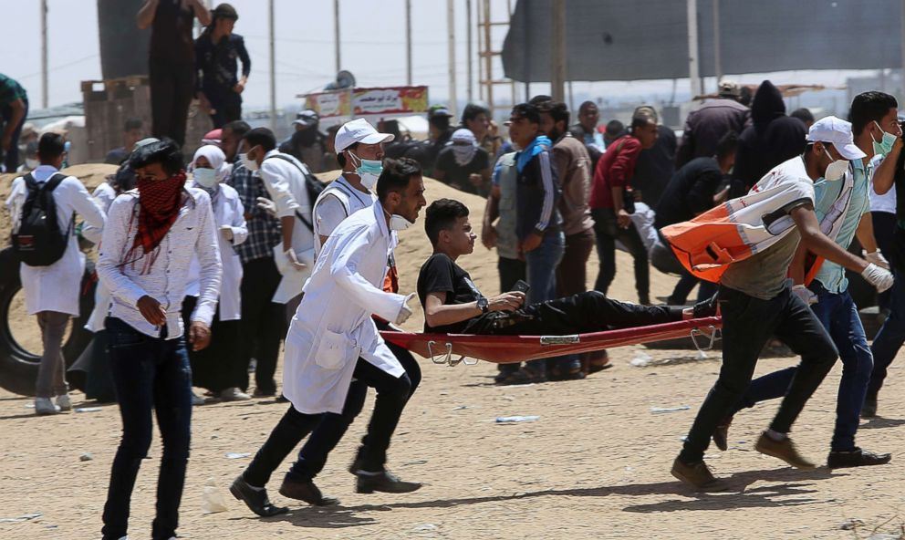 PHOTO: Palestinian medics evacuate a wounded youth during a protest at the Gaza Strip's border with Israel, May 11, 2018.