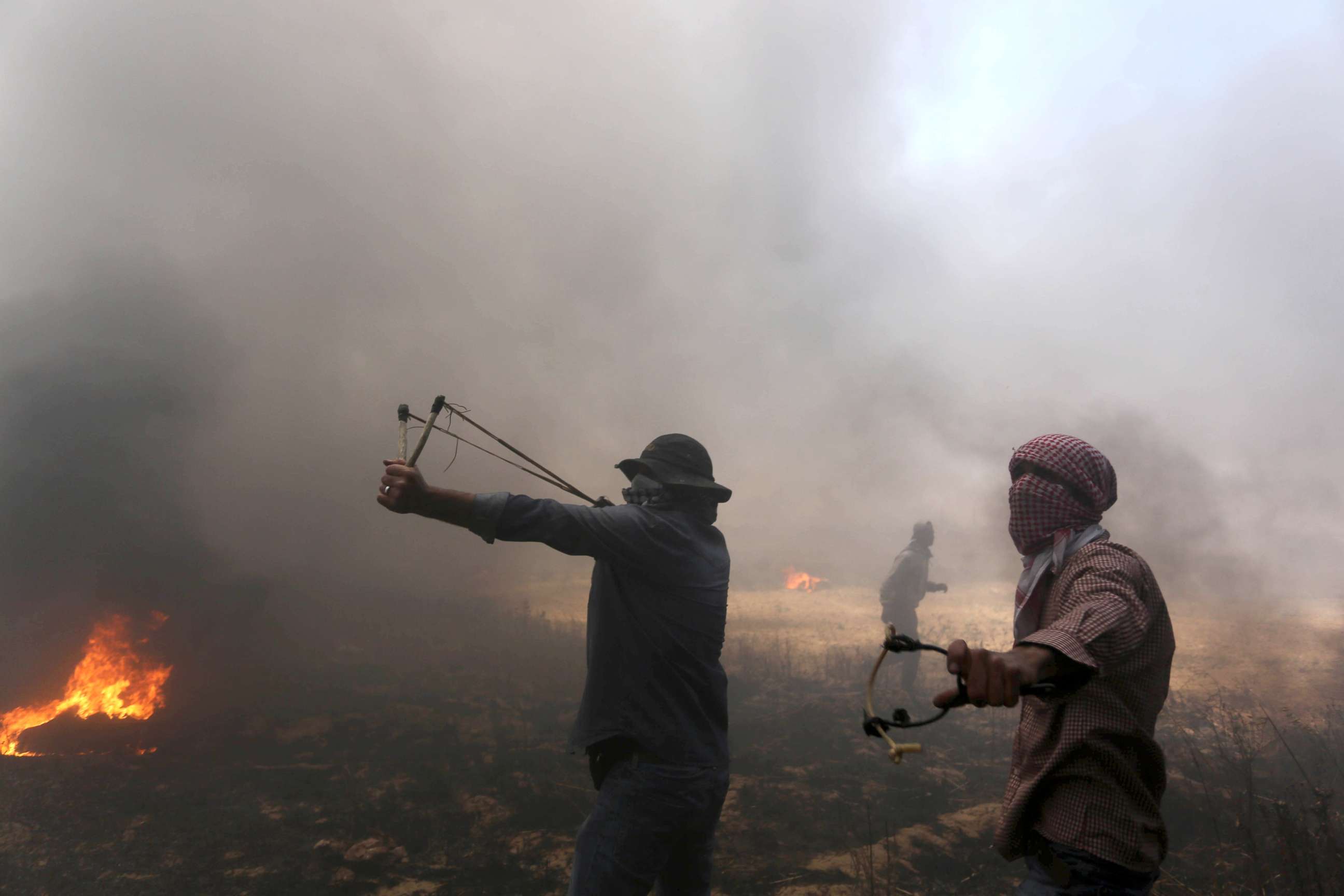 PHOTO: Palestinian protesters take part during clashes with Israeli soldiers at the border fence with Israel east of Khan Yunis in the southern Gaza Strip, Palestine, May 15, 2018.