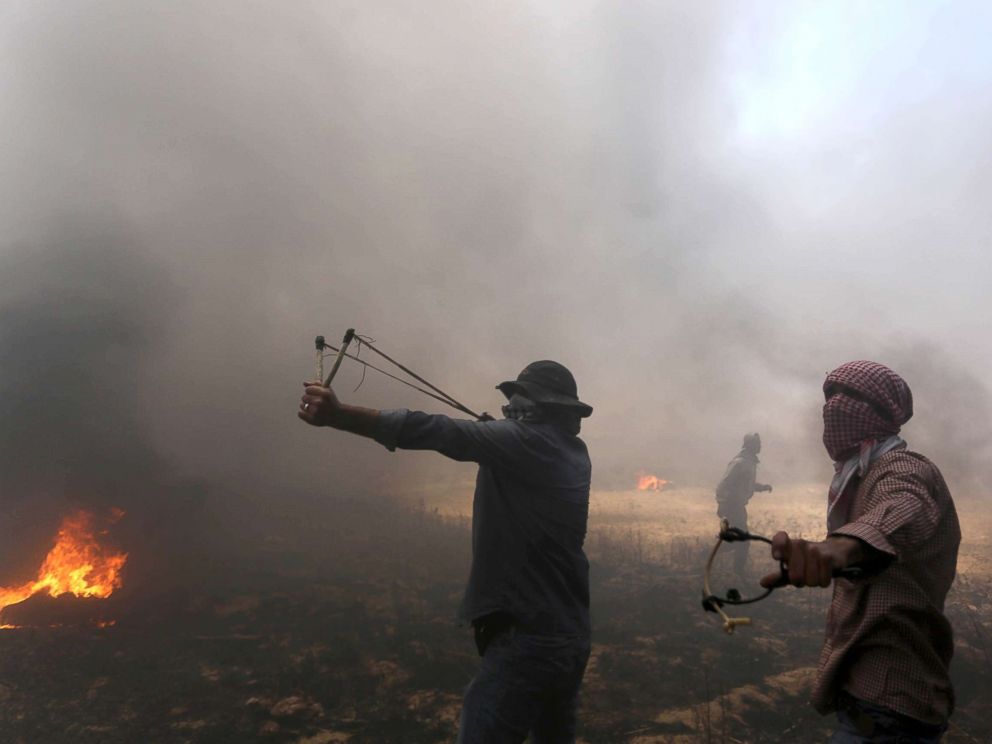 PHOTO: Palestinian protesters take part during clashes with Israeli soldiers at the border fence with Israel east of Khan Yunis in the southern Gaza Strip, Palestine, May 15, 2018.