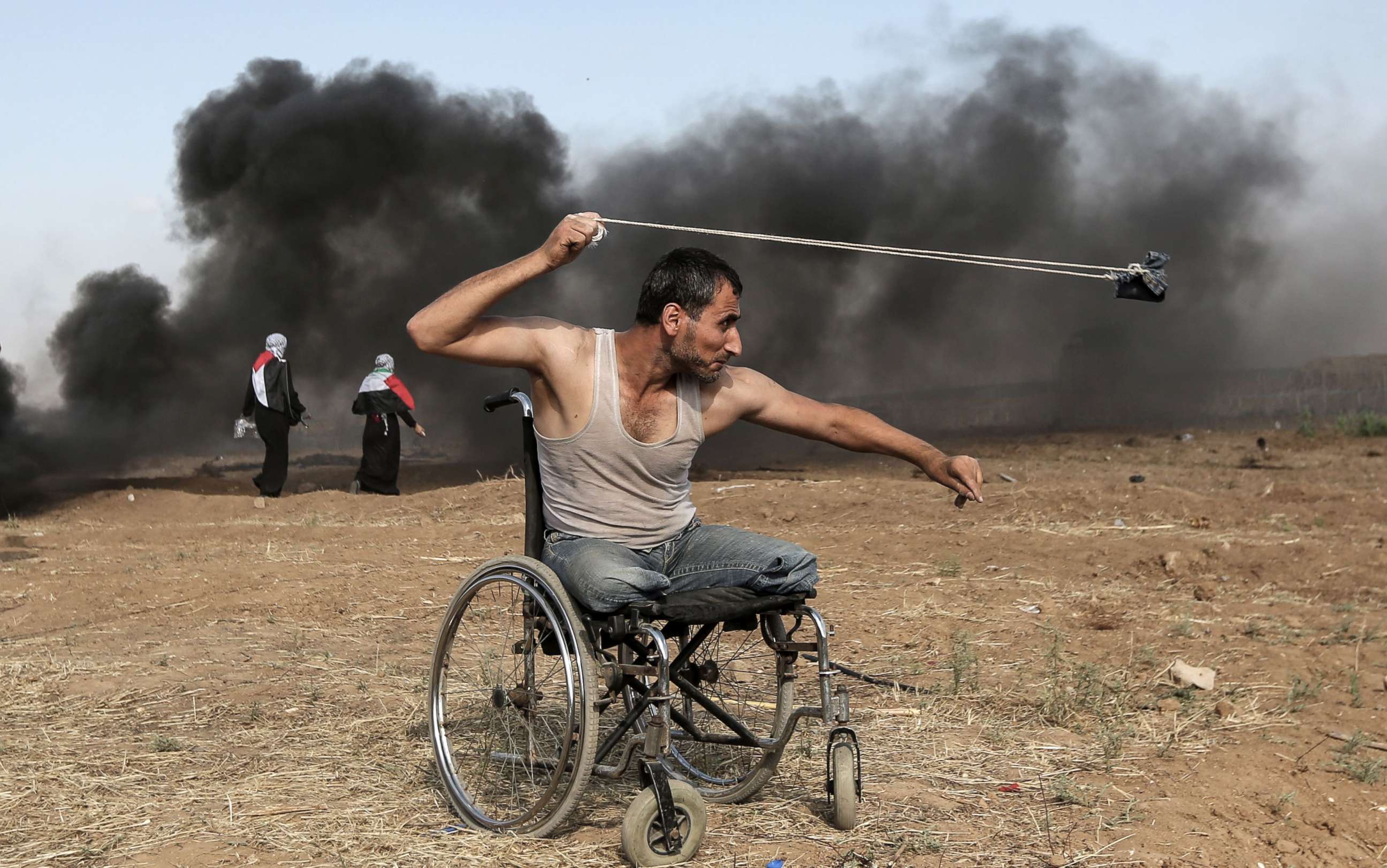 PHOTO: Palestinian Saber al-Ashkar, 29, hurls rocks during clashes with Israeli forces along the border with the Gaza strip, east of Gaza City, May 11, 2018.