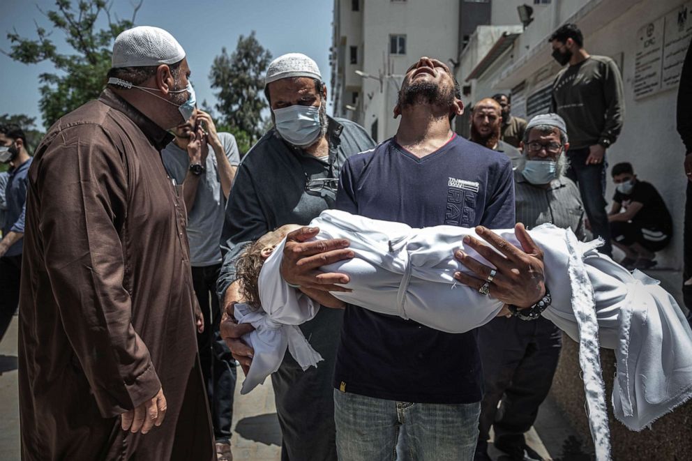 PHOTO: A Palestinian man mourns his children who were killed in a violent Israeli raid in the central Gaza Strip on May 16, 2021, in Gaza City, Gaza.
