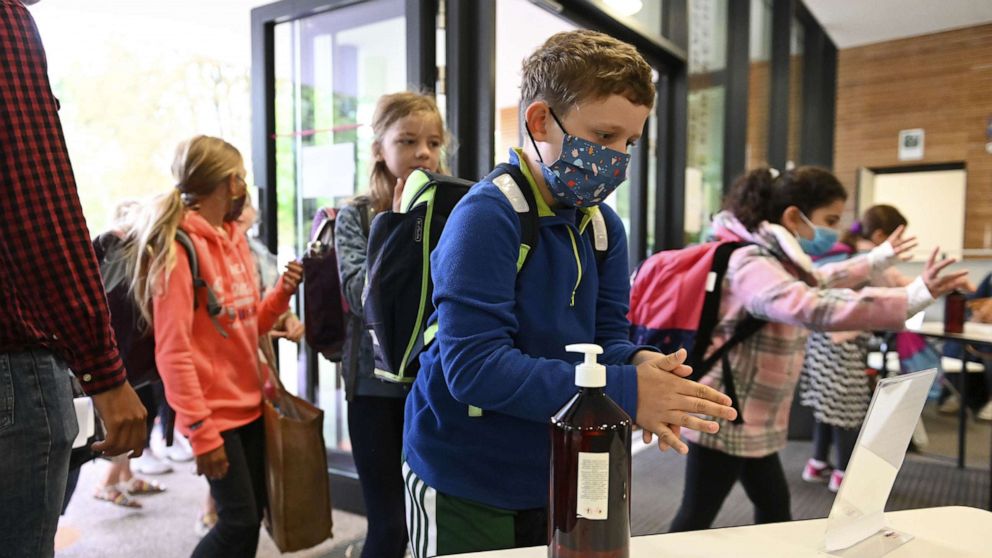 PHOTO: Pupils use hand sanitizer as they walk in the Europeen school of Strasbourg, eastern France, on Sept. 1, 2020.