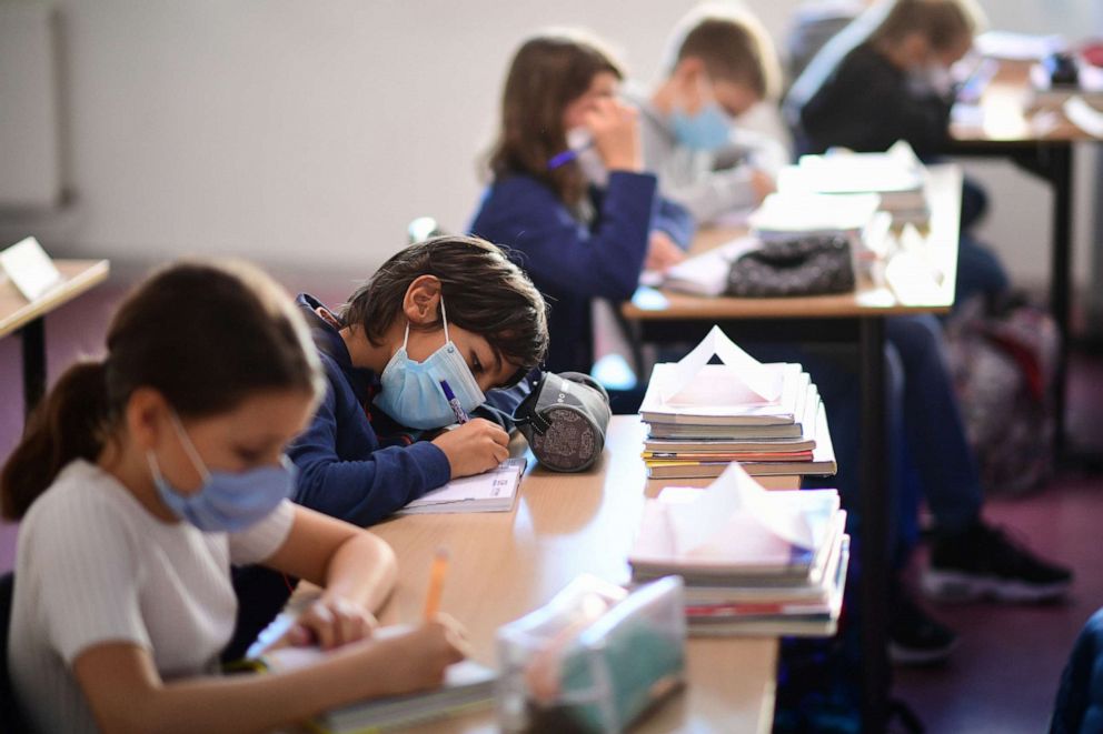 PHOTO: Pupils wearing protective masks write during a class in Vincennes, east of Paris, on Sept. 1, 2020.