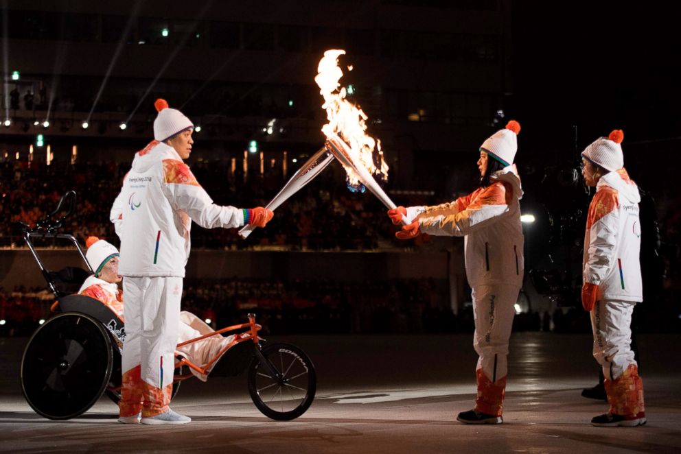 PHOTO: Seo Soon seok and Kim Eun Jung of South Korea take the flame during the opening ceremony of the Pyeongchang 2018 Winter Paralympic Games at the Pyeongchang Stadium on March 9, 2018.