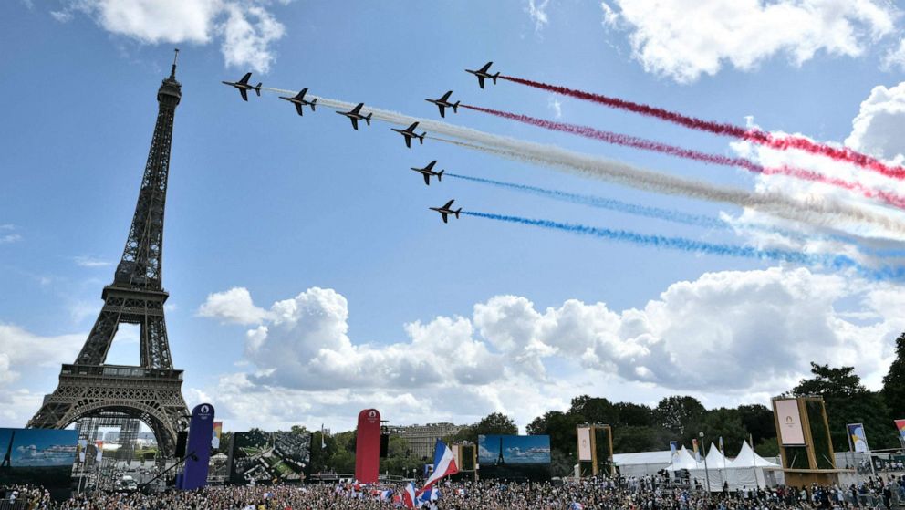 PHOTO: French aerial patrol 'Patrouille de France' fly over the fan village of The Trocadero set in front of The Eiffel Tower, in Paris on Aug. 8, 2021 upon the transmission of the closing ceremony of the Tokyo 2020 Olympic Games.