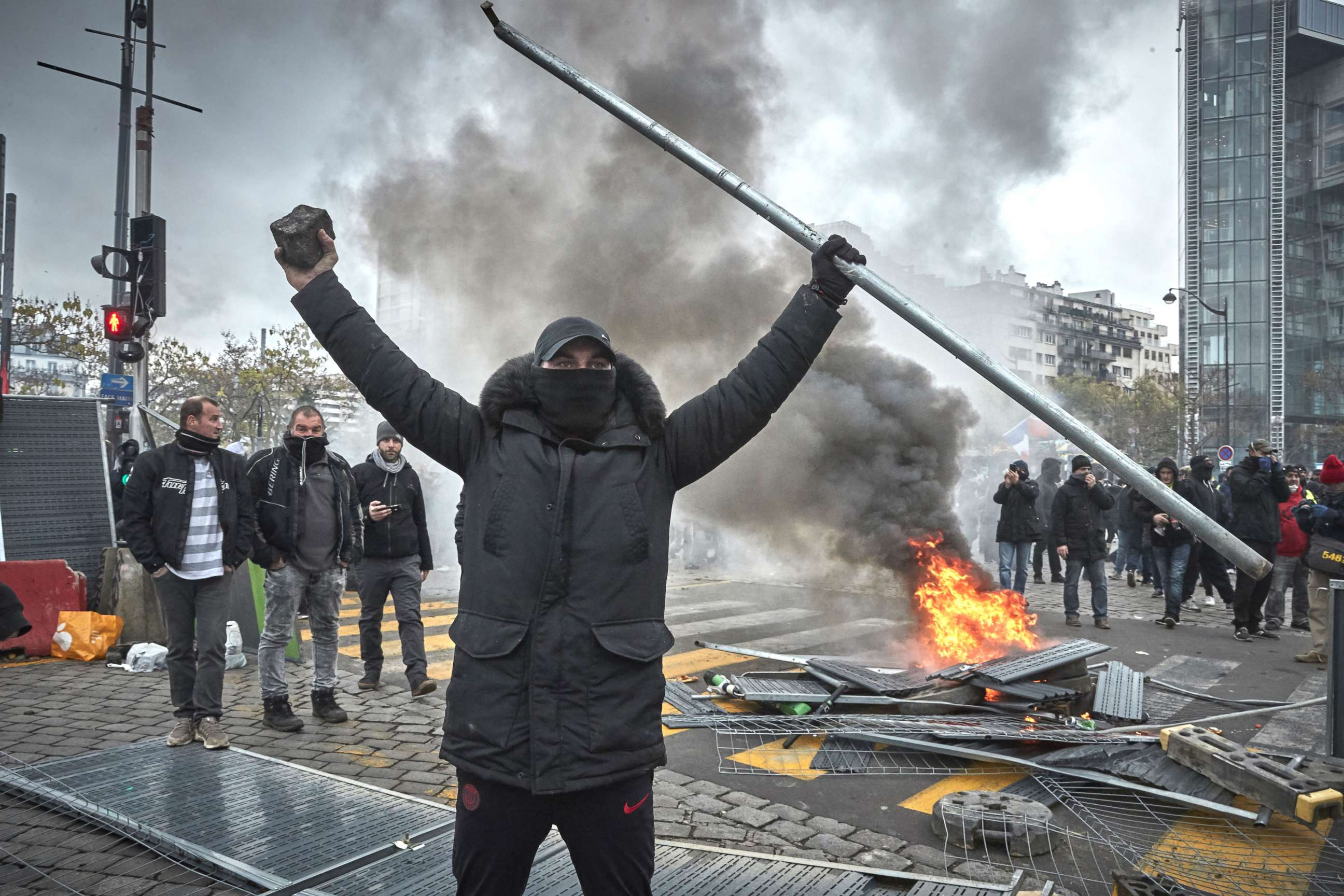 PHOTO: A Gilet Jaune, or Yellow Vest, protestor walks amongst tear gas as protests to mark the Anniversary of the Gilets Jaune movement turn violent at Place d'Italie with thousands of protesters converging on the French capital.