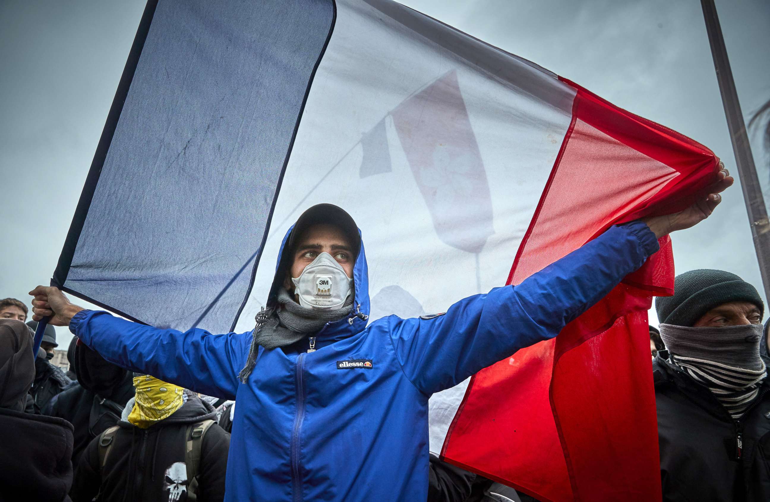 PHOTO: A Gilet Jaune, or yellow vest protestor holds a French Tricolor Flag as protests turn violent as tens of thousands of protesters converge on the French capital to mark the first anniversary of the movement, on November 16, 2019 in Paris, France.