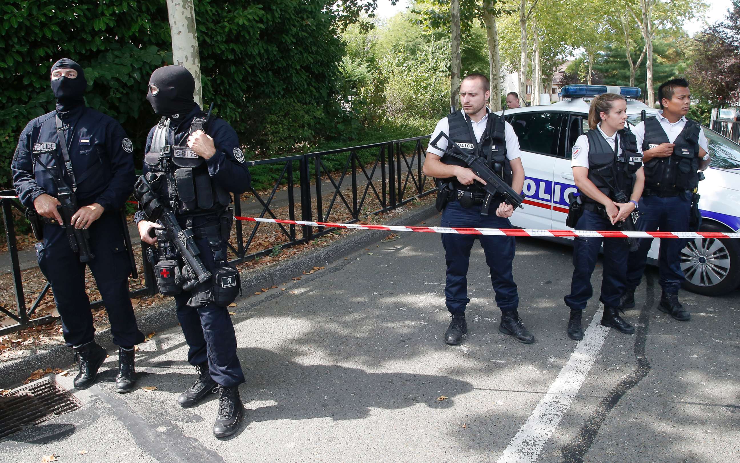PHOTO: French police officers guard the area with other police officers after a knife attack Aug. 23, 2018 in Trappes, west of Paris.