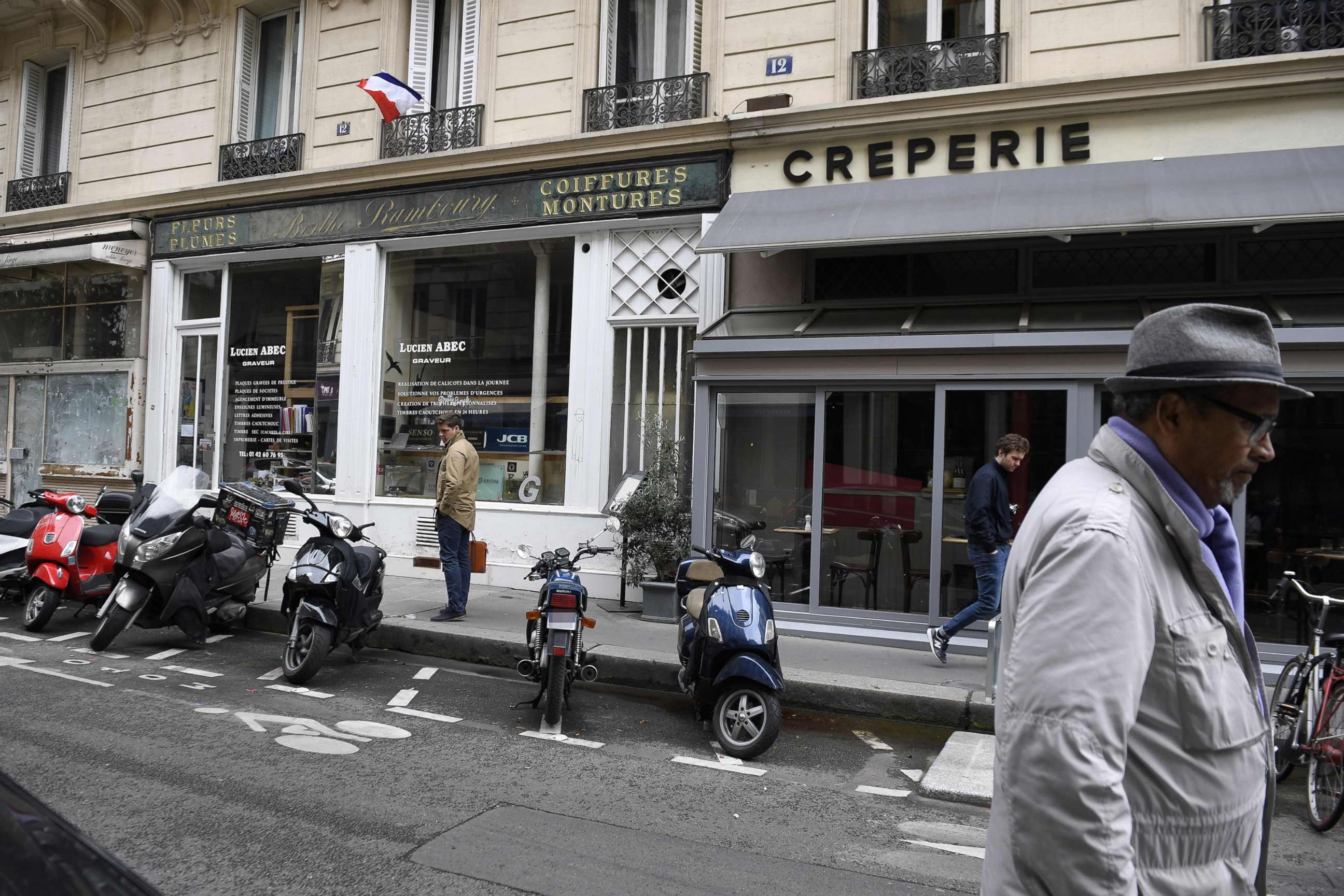 PHOTO: People walk on Monsigny street in Paris, May 13, 2018, on the site where a man attacked several people with a knife the night before.