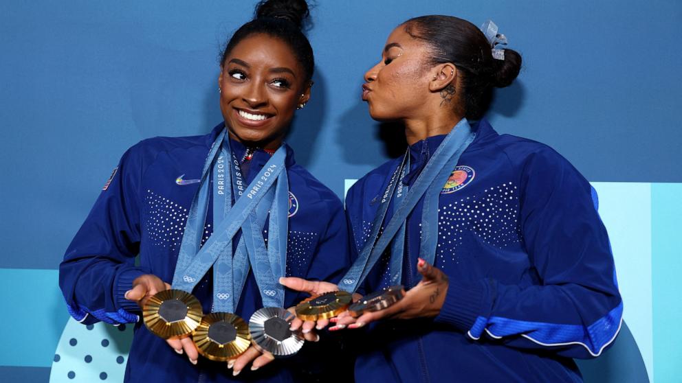 PHOTO: Gymnast Simone Biles of the U.S. displays her three gold medals and silver medal while Jordan Chiles displays her gold and bronze medals won during the women's artistic gymnastics competition at the 2024 Paris Olympics, Aug 5, 2024.