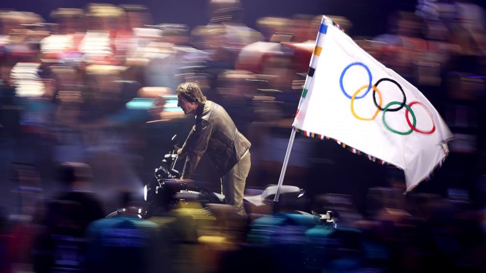 PHOTO: Actor Tom Cruise rides on a motorcycle with the Olympic flag during the Closing Ceremony of the 2024 Paris Olympics, Aug. 11, 2024.