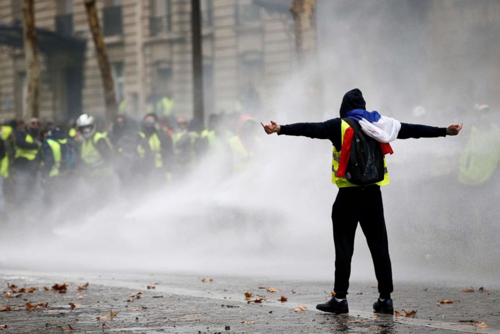 PHOTO: Protesters wearing yellow vests, a symbol of a French drivers' protest against higher diesel taxes, face off with riot police during clashes at the Place de l'Etoile in Paris, Dec. 1, 2018.