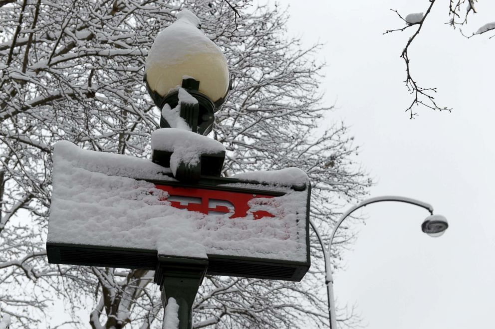 PHOTO: A metro sign is covered with snow at the Avenue de la Grande Armee in Paris, Feb. 7, 2018.