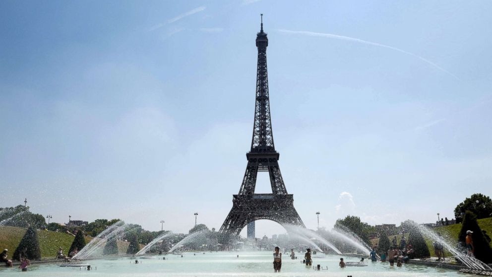 People cool themselves at the Trocadero Fountain in front of the Eiffel Tower in Paris, July 27, 2018.