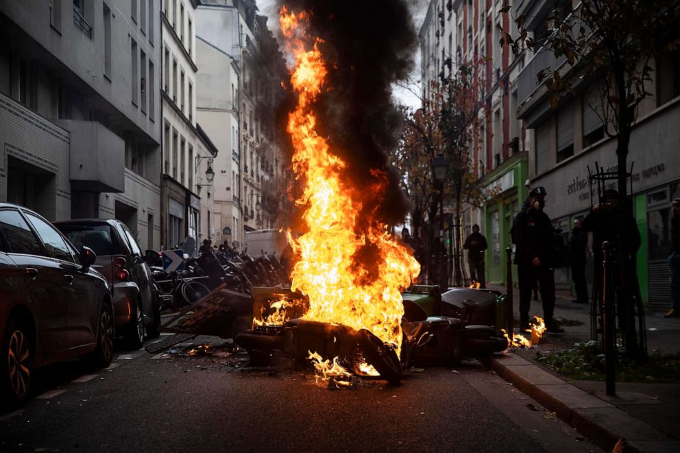 PHOTO: A fire is seen at the first anniversary of the yellow vest protest at the Place d'Italie in Paris.