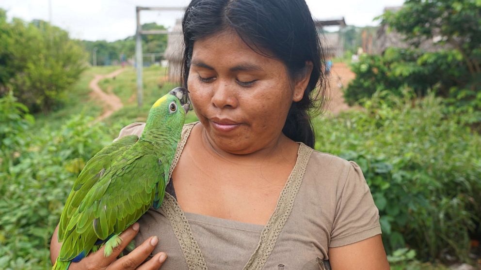 PHOTO: A Kakataibo woman and her pet bird in Peru’s Ucayali region. Over 30 million people, including scores of indigenous tribes, rely on the forests and rivers of the Amazon rainforest.
