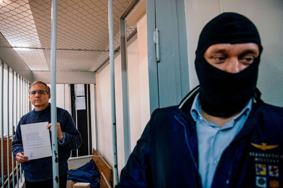 PHOTO: Paul Whelan, a former U.S. Marine accused of espionage and arrested in Russia in December 2018, holds a message as he stands inside a defendants' cage before a hearing at the Lefortovo Court in Moscow, Oct. 24 2019.