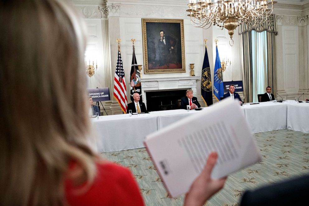 PHOTO: CBS White House correspondent Paula Reid, left, holds a copy of John Bolton's "The Room Where It Happened," in the State Dining Room of the White House, June 18, 2020, in Washington.
