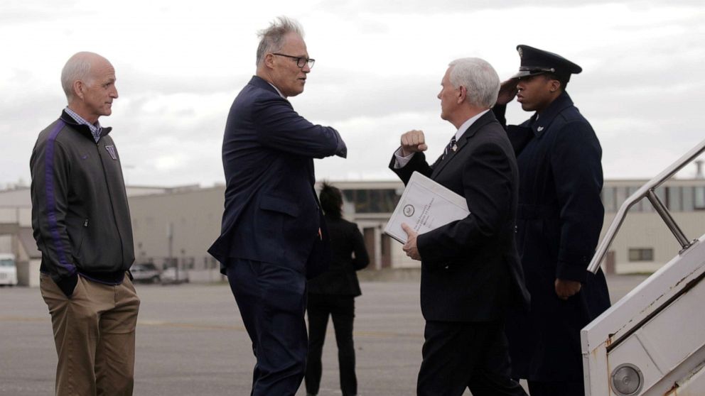 PHOTO: Governor Jay Inslee greets Vice President Mike Pence, who heads the government's coronavirus task force, with an elbow bump at Joint Base Lewis-McChord near Tacoma, Washington, March 5, 2020.