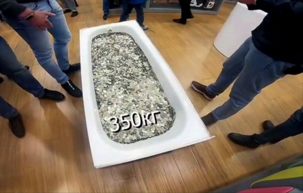 PHOTO: A group of people dragged an entire bathtub full of coins to a shopping mall in Moscow to buy an iPhone XS, on Nov. 13, 2018.