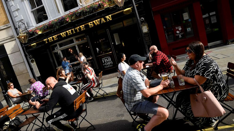 PHOTO: People drink outside a pub at the Covent Garden shopping and dining district in London, United Kingdom, on Aug. 2, 2020.