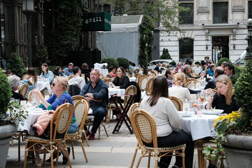 PHOTO: People dine outside at a restaurant at Bryant Park in Manhattan, May 4, 2021 in New York City.
