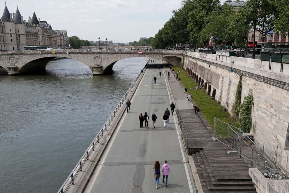 PHOTO: People stroll along the Seine River in Paris, France, on May 11, 2020.
