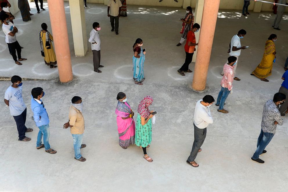 PHOTO: Residents wait in a queue to register to get tested for a COVID-19 test at a free testing center in Hyderabad, the capital of southern India's Telangana state, on Sept. 9, 2020.