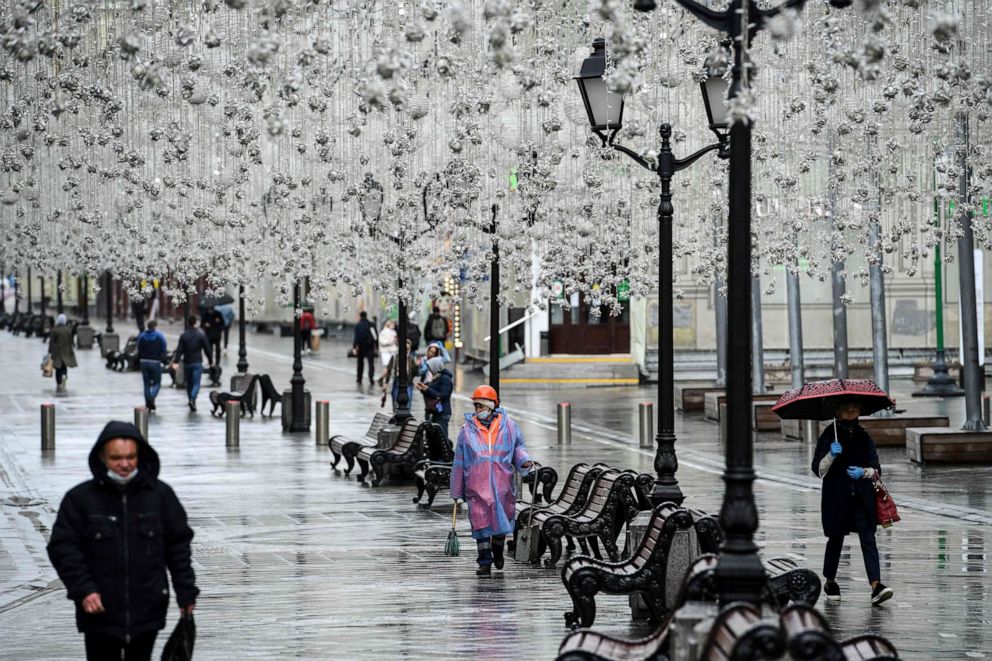 PHOTO: People walk during a light rain shower on a street in downtown Moscow, Russia, on June 1, 2020.