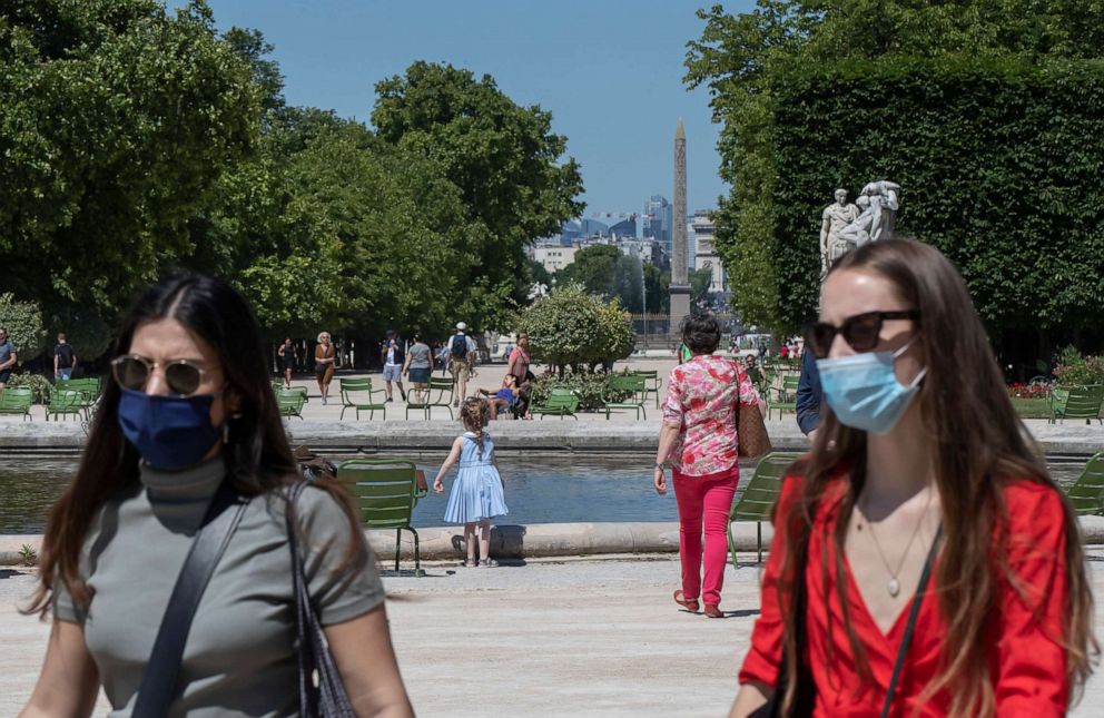 PHOTO: People wear face masks to protect against the novel coronavirus while walking at the Tuileries Garden in Paris on June 1, 2020, as France gradually lifts its lockdown.