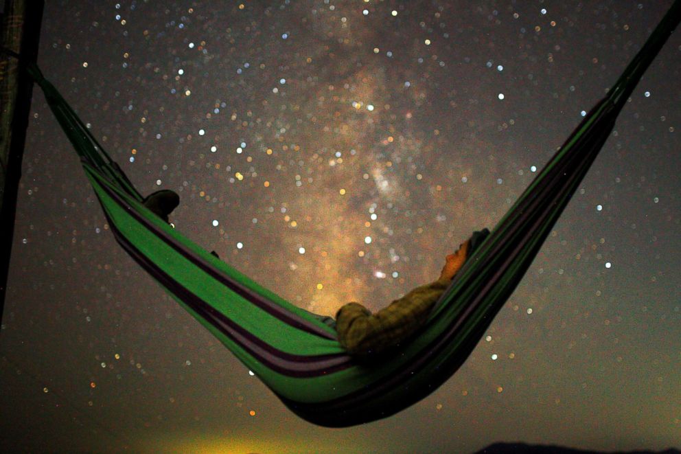 PHOTO: A girl lies in hammock as she looks at the milky way during the peak of Perseid meteor shower in Kozjak, Macedonia, Aug. 13, 2018.