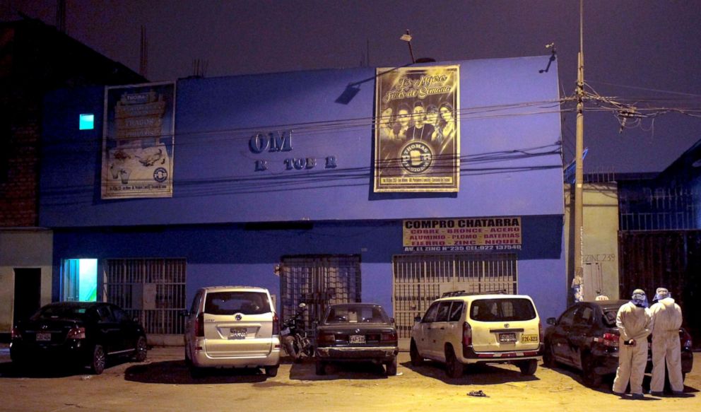 PHOTO: Police officers, wearing protective clothing, stand outside a disco in Lima, Peru, Aug. 23, 2020.
