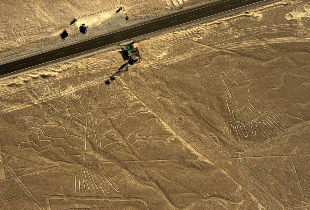 PHOTO: An aerial view of geoglyphs representing a guarango tree (L) and hands are pictured in the Nazca desert, in southern Peru in this Dec. 11, 2014 file photo. 