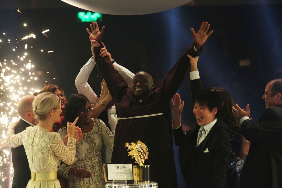 PHOTO: Kenyan teacher Peter Tabichi, center, reacts after winning the $1 million Global Teacher Prize in Dubai, United Arab Emirates, March 24, 2019.