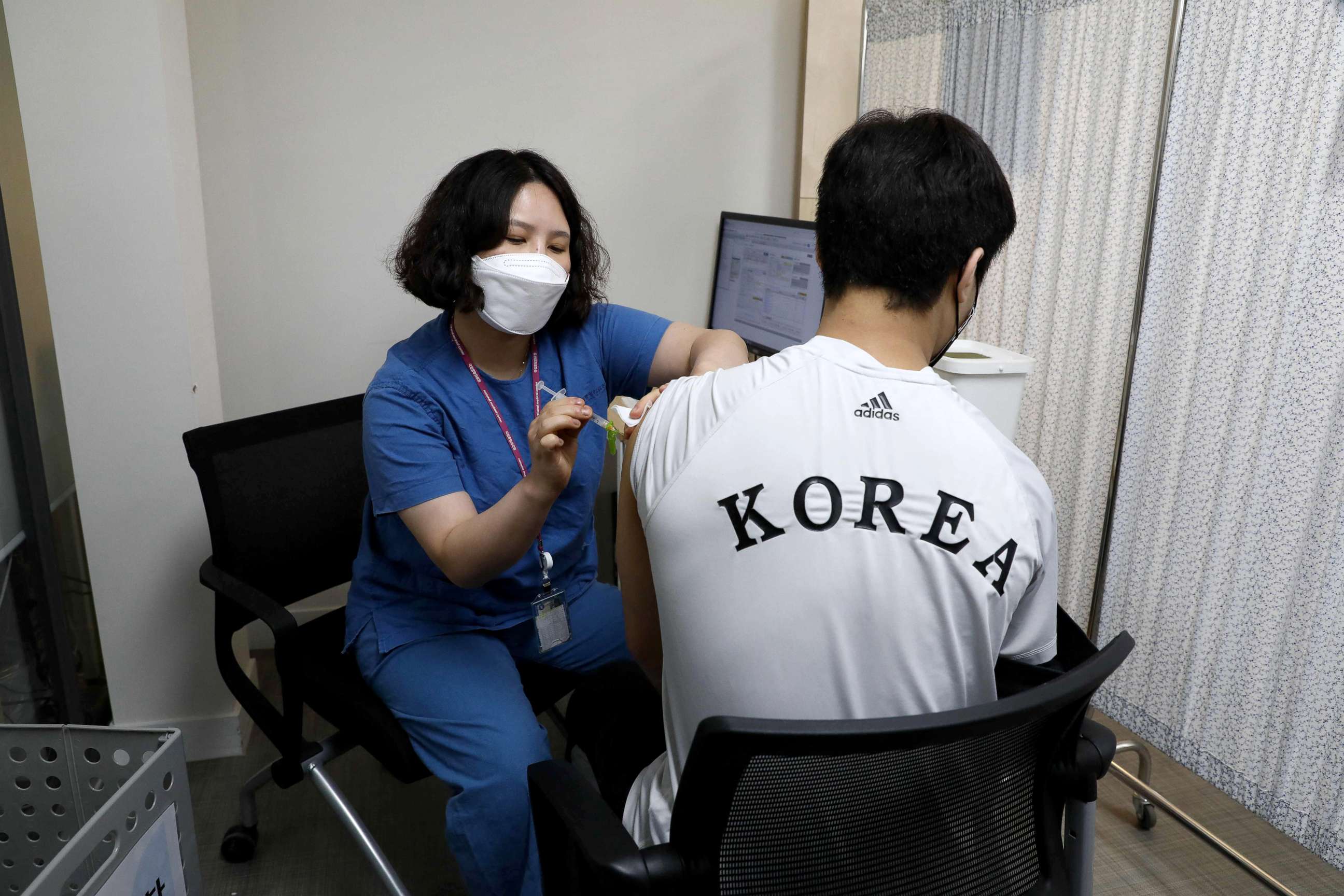 PHOTO: South Korean Olympic judo team member An Ba-ul receives the first dose of the Pfizer-BioNTech Covid-19 coronavirus vaccine at the National Medical Center in Seoul, April 29, 2021.