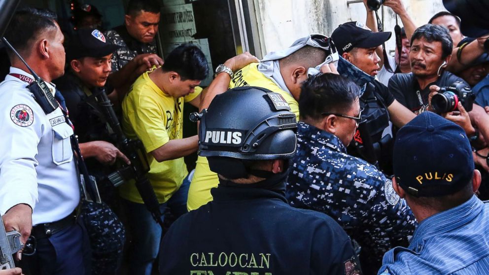PHOTO: Two of three police officers are escorted out of the courtroom after being found guilty and sentenced up to 40 years without parole for the killing of a student, Nov. 29, 2018, in Caloocan city, Philippines.