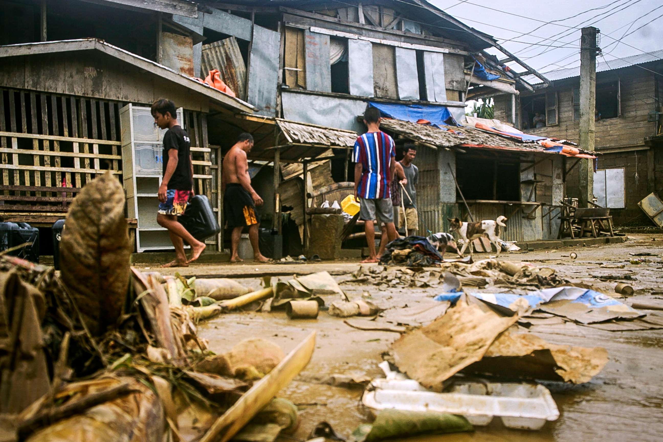 PHOTO: Residents clean out debris from floods caused by Typhoon Surigae in Arteche, Eastern Samar, eastern Philippines, April 20, 2021.