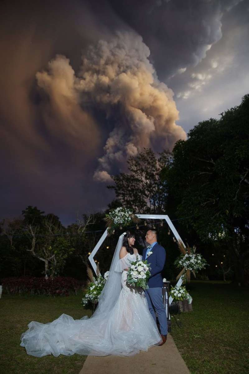 PHOTO: A photographer captured this couple on their wedding day while The Taal Volcano, near the capital of Manila, spewed ash on Jan. 12, 2020. 