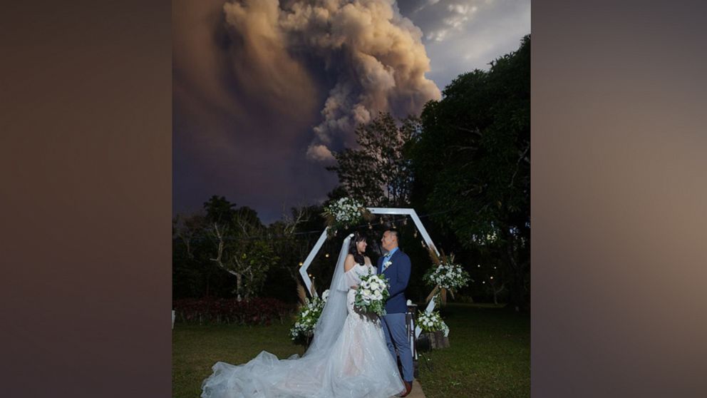 While tens of thousands of people have been evacuated in the Philippines, a nearby wedding went on as planned. 