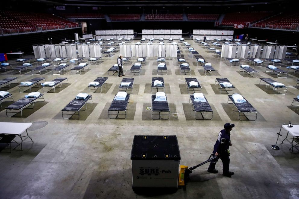 PHOTO: A worker moves items at a federal medical station as it is set up as a field hospital at Temple University's Liacouras Center in Philadelphia, March 30, 2020.