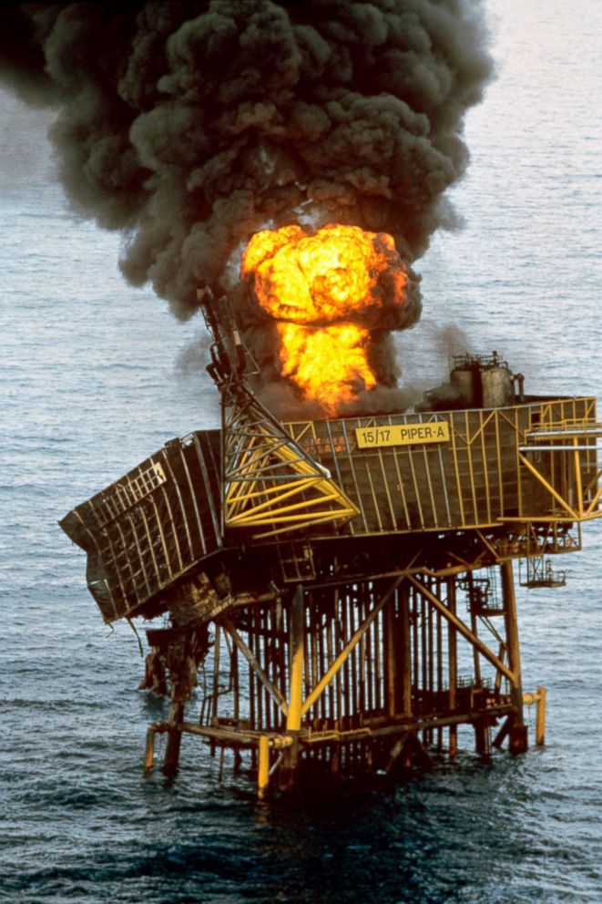 PHOTO: The wreckage of the Piper Alpha oil production platform still burns in the North Sea, off Aberdeen, July 7, 1988.