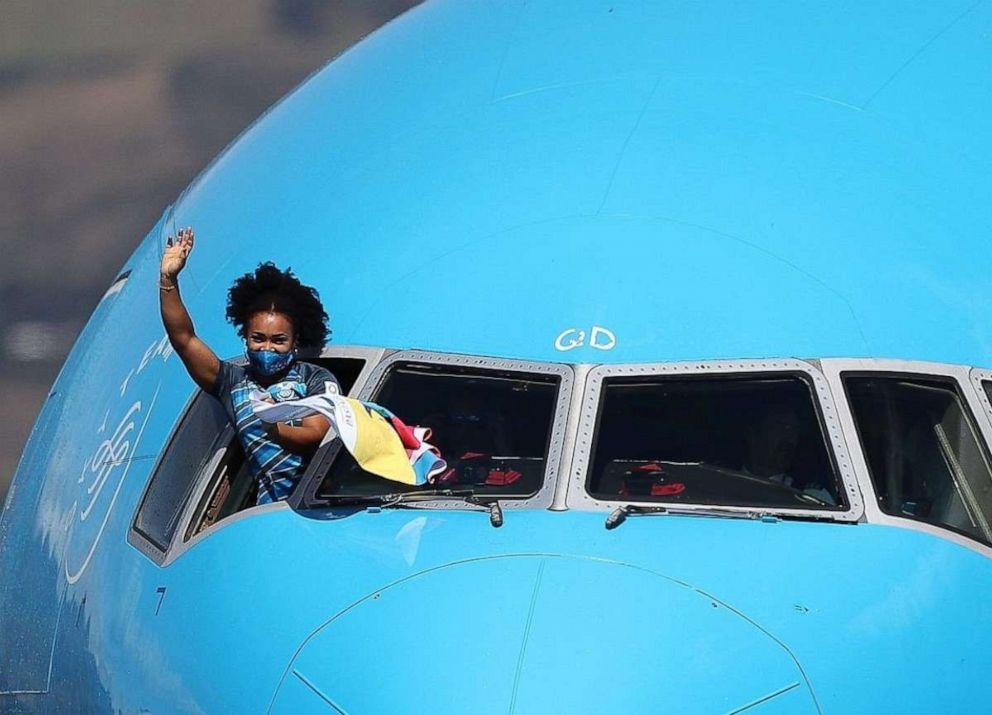 PHOTO: Ecuadorian weightlifter Neisi Dajomes, winner of the gold medal at 76 kg category in Tokyo, gestures out the window of a plane upon her arrival in Quito, Ecuador, Aug. 4, 2021.