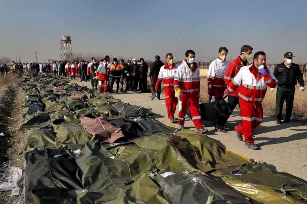 PHOTO: Rescue workers carry the body of a victim of a Ukrainian plane crash in Shahedshahr, southwest of the capital Tehran, Iran, Jan. 8, 2020.