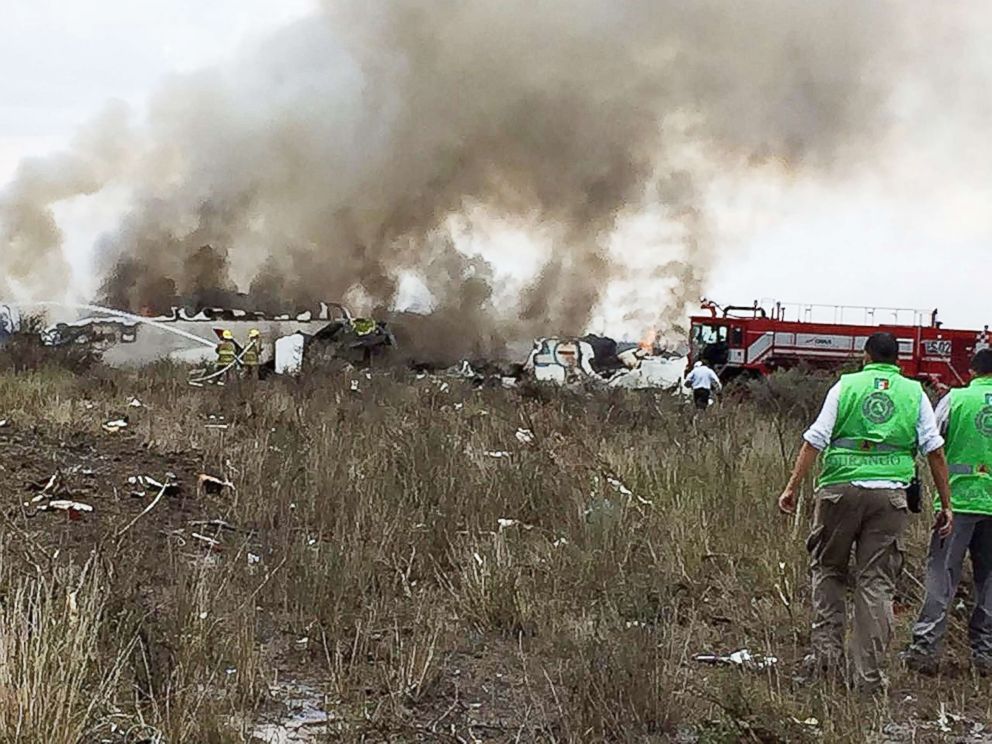 PHOTO: A handout photo made available by the Civil Protection State Coordination (CPCE) shows emergency personnel at the site where an Aeromexico plane crashed, in Durango, Mexico, July 31, 2018.