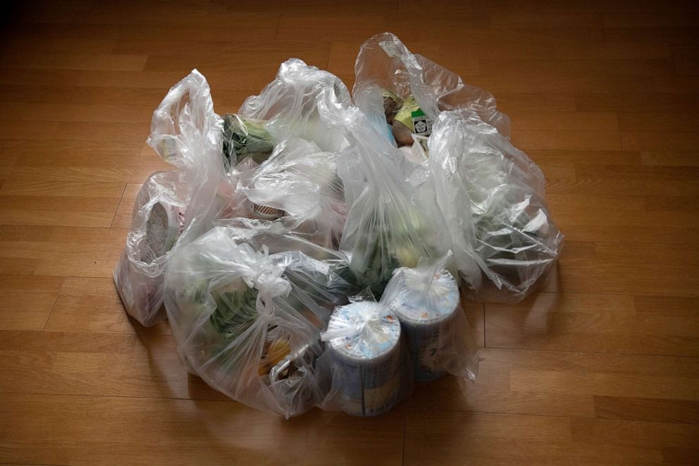PHOTO: A home food delivery is brought to a house in multiple plastic bags, Nov. 9, 2020 in Tokyo, Japan.