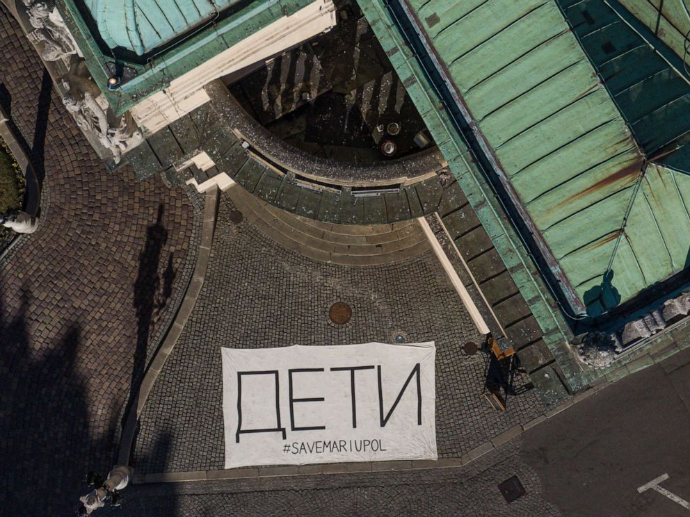 PHOTO: An aerial view of a banner saying "children" in Russian language is seen by the entrance of the Slowaskiego Theatre as a sign of solidarity with the Ukrainian victims of Mariupol Theatre that was bombed by Russians, March 29, 2022, in Poland.